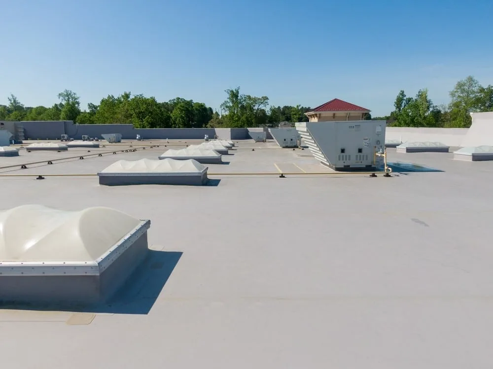 Completed low-slope commercial roof with skylights and rooftop mechanical equipment